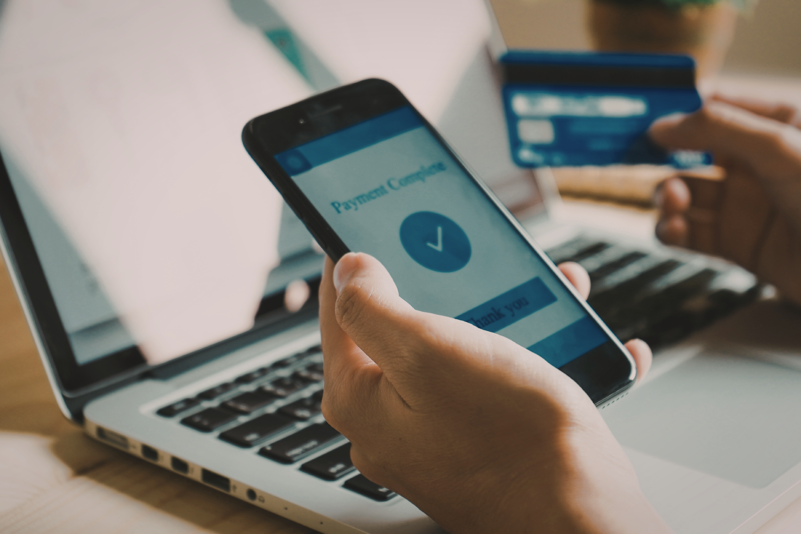 Person holding cell phone and completing payment