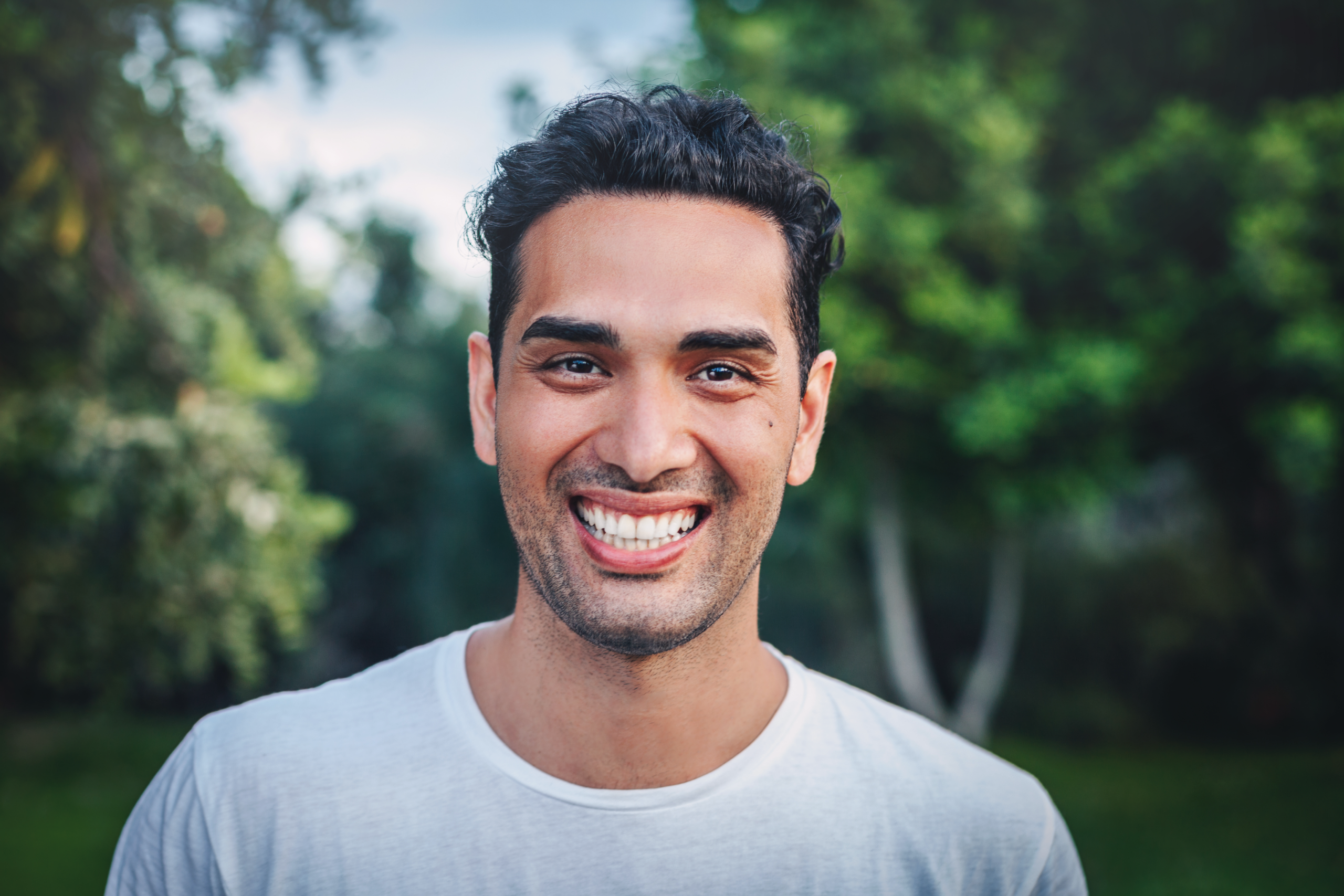 Man Smiling with foliage